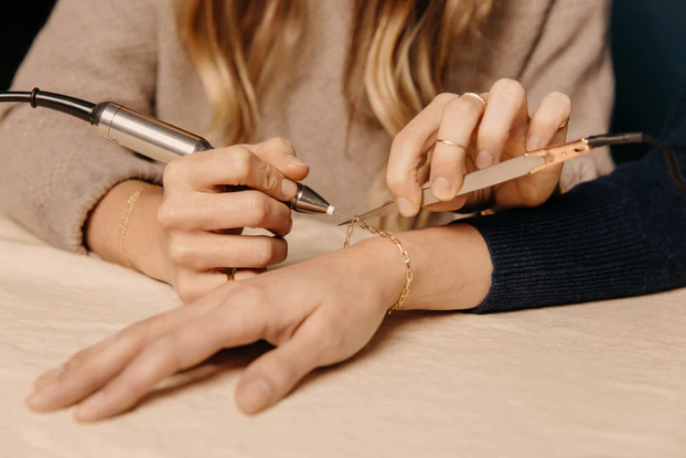 welded_bracelet_being_put_on_up_close_622x.webp