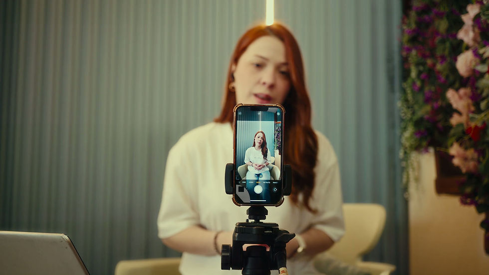 Woman speaks directly to camera and gestures with her hands while recording on a smartphon