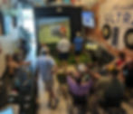 Group of golfers waiting their turn on a digital golf simulator