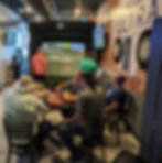 Golfers watching a digital golf simulator