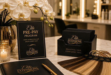 Elite Pre-Pay Program display at Elite Extensions salon in Highland, Michigan, featuring branded cards, hair extension color swatches, and elegant table styling