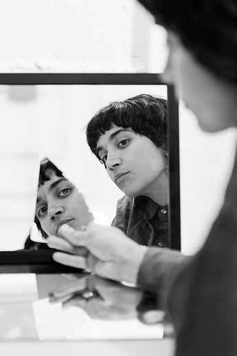 a woman looking at her reflection