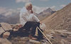 John Paul II sitting in the mountains looking out and hiking