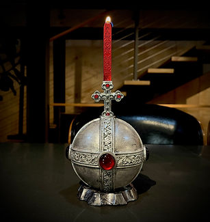 Image of globus cruciger orb in silver tone with cross above, and a red wax candle on top
