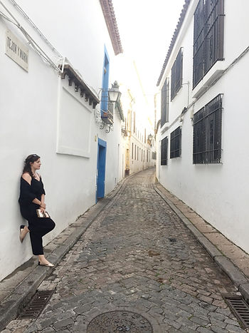 Narrow, white-washed cobblestone street in Cordoba.