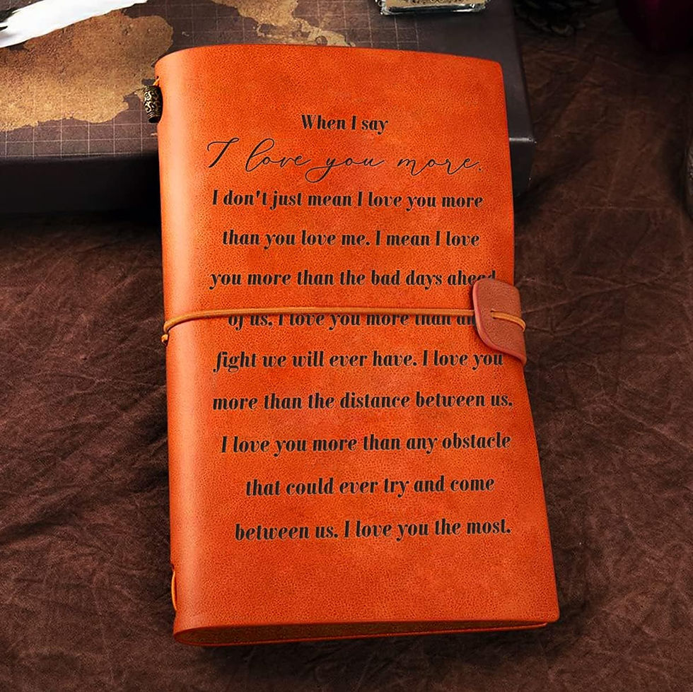 Brown leather journal with heartfelt text about love embossed on the cover. It's set on a textured, dark brown surface, creating a warm ambiance.