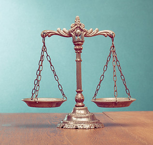 An empty two-pan balance scale set on a table.
