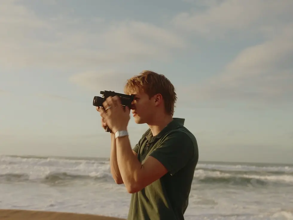 Director filming on a beach with treatment templates.