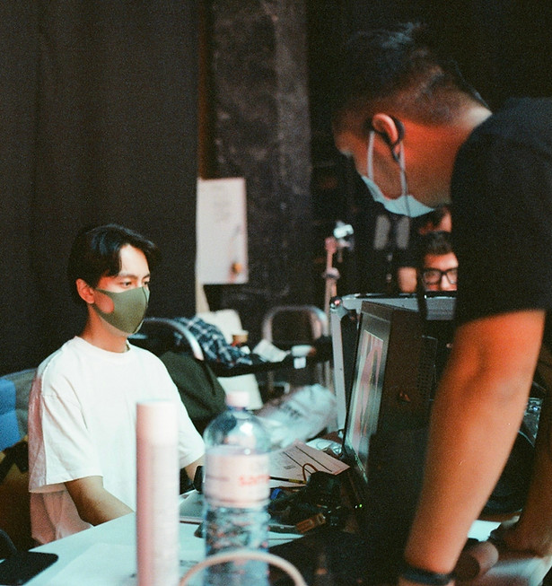 a commercial film director seated in a production studio directing a commercial.