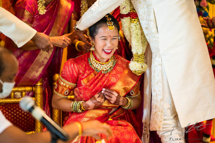Bride laughing during Hindu wedding ceremony