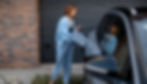 Woman charging vehicle at home