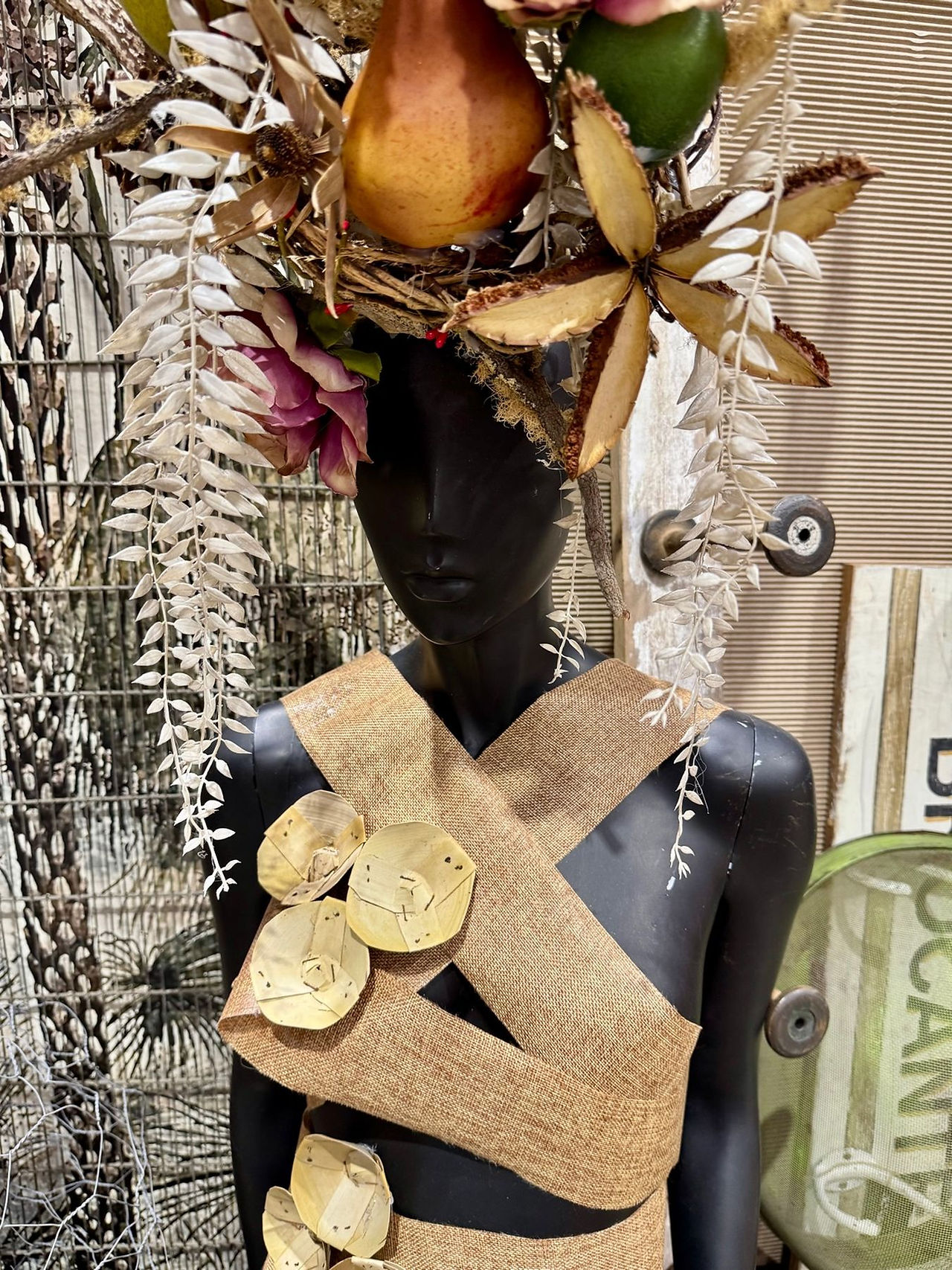 Decorative paperwork art arranged on a mannequin with natural textures and botanical elements, photographed for a blog about how travel in Australia inspires design lovers.