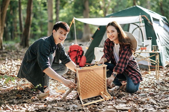 pretty-camper-girl-preparing-firewood-with-boyfriend-start-campfire-young-tourist-couple-h