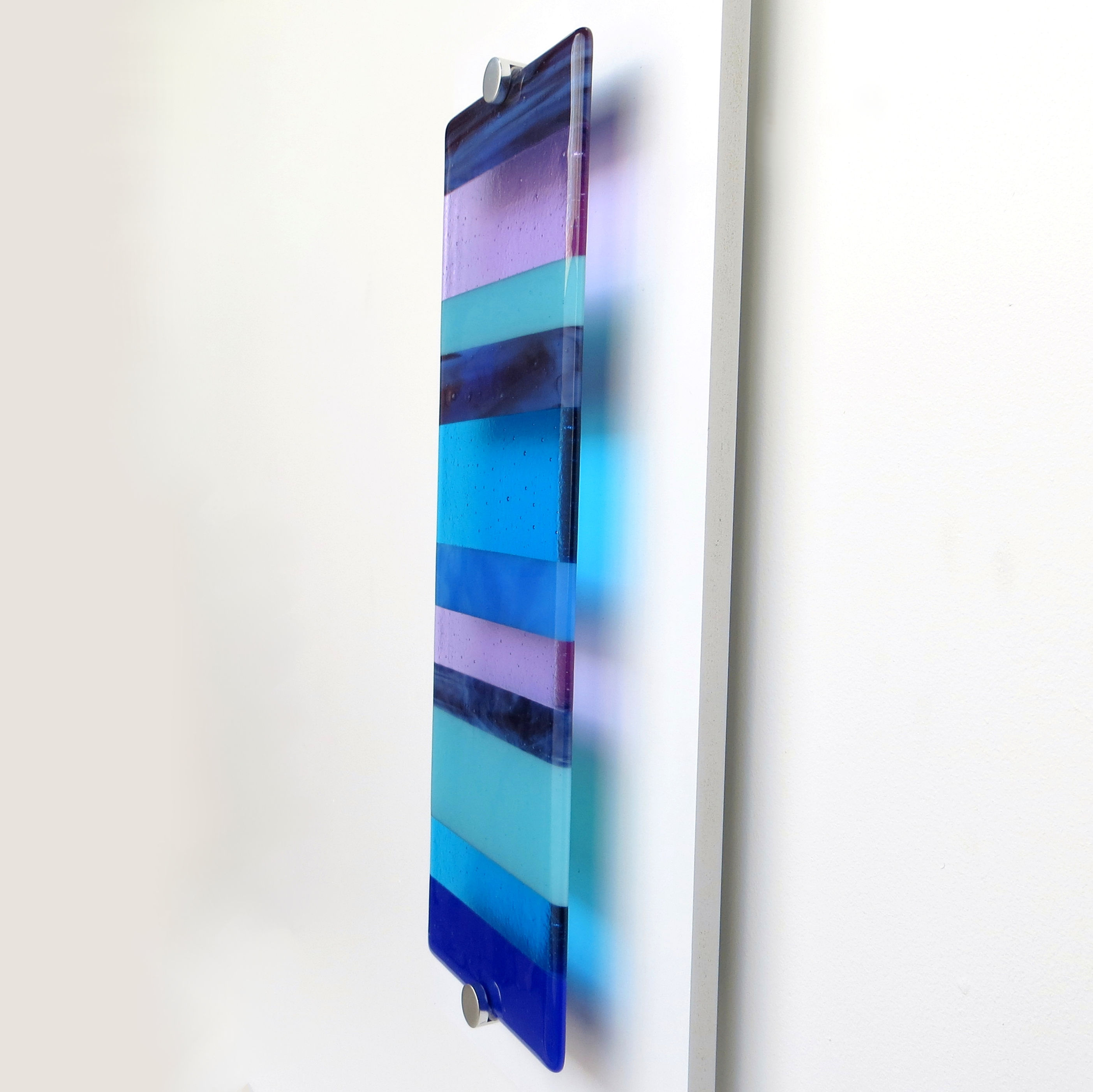 Blue and purple striped fused glass wall panel