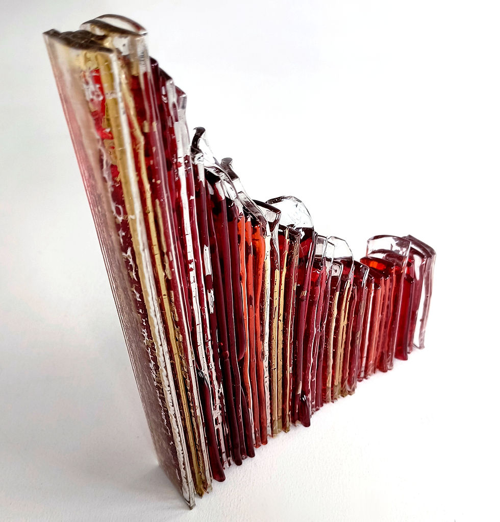 Thumbnail: Red and amber wave-like abstract fused glass sculpture