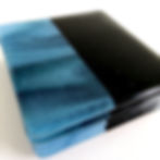 Set of four black and green patterned fused glass coasters