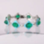 Emerald cabochon and diamond bracelet with a fluid white gold link design