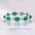 Emerald cabochon tennis bracelet with diamond halo settings and turquoise accents in white gold