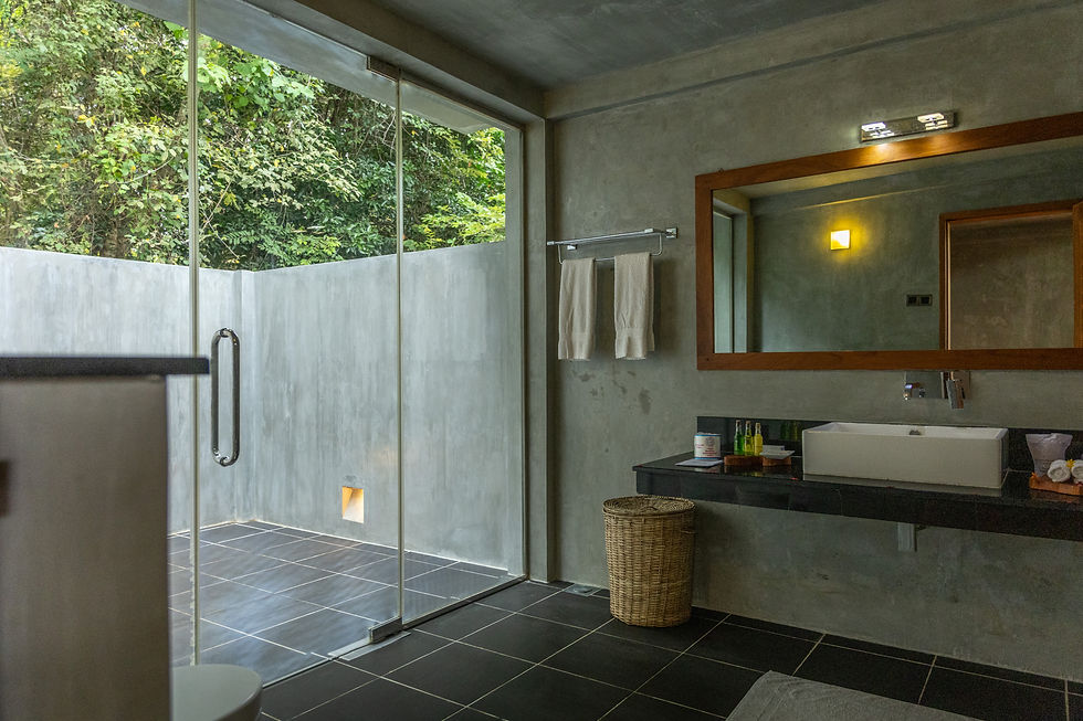 Private bathroom and outdoor shower in a Deluxe Villa at Wild Grass Nature Resort