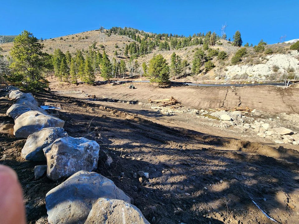 Looking upstream on October 22, 2024. Tree trunks and rocks are staged for stream restoration