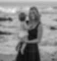 mom holding her baby on the beach