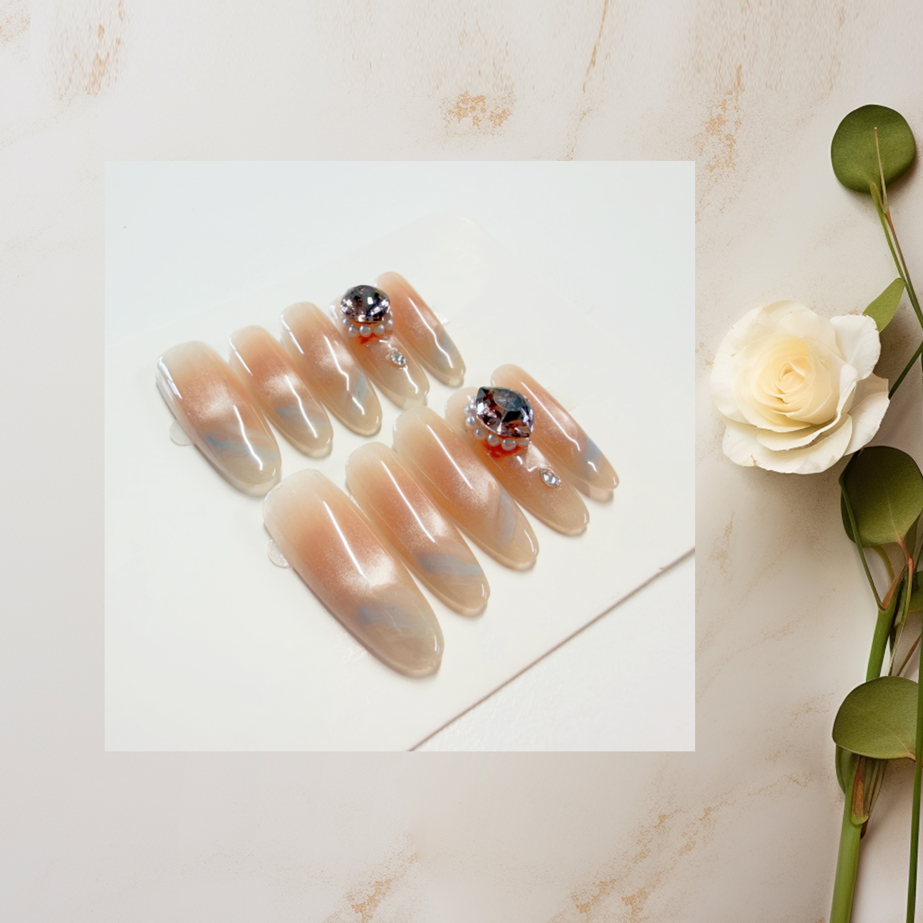 Nude Long Stiletto Press-On Nails with Hand-Painted Blue Ribbon & Rhinestones