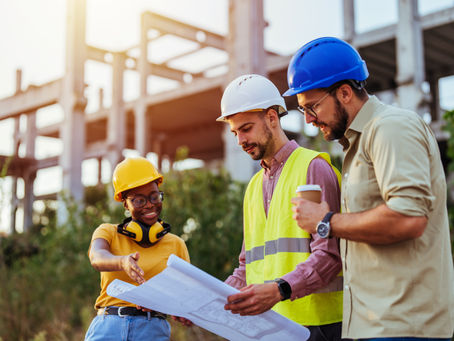 Three Construction Workers Looking at a Map