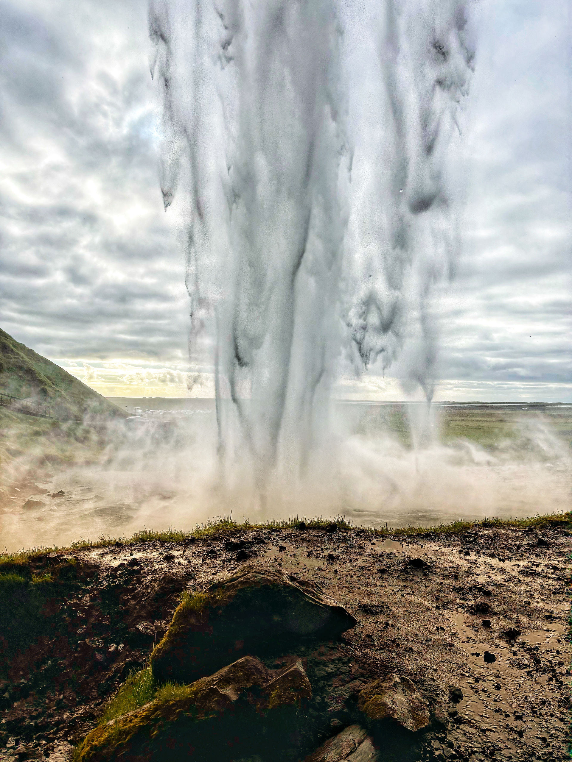 View from behind the  Seljalandsfoss waterfall. Shot with iPhone 15.