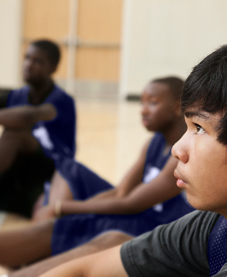 Basketball Players Listening to Coach