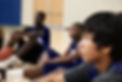 Basketball Players Listening to Coach
