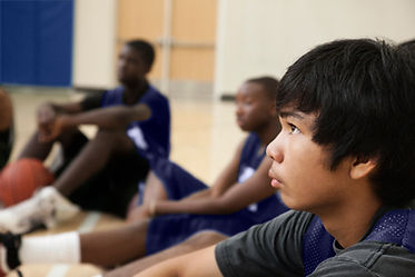 Basketball Players Listening to Coach