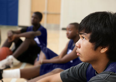 Basketball Players Listening to Coach