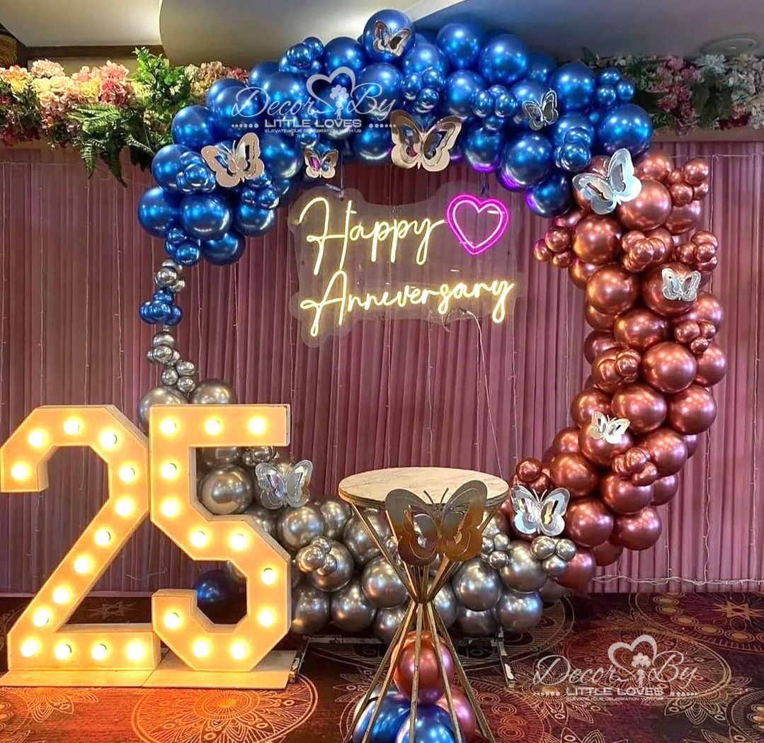 Anniversary celebration with illuminated 25, balloons, and neon sign: Happy Anniversary.