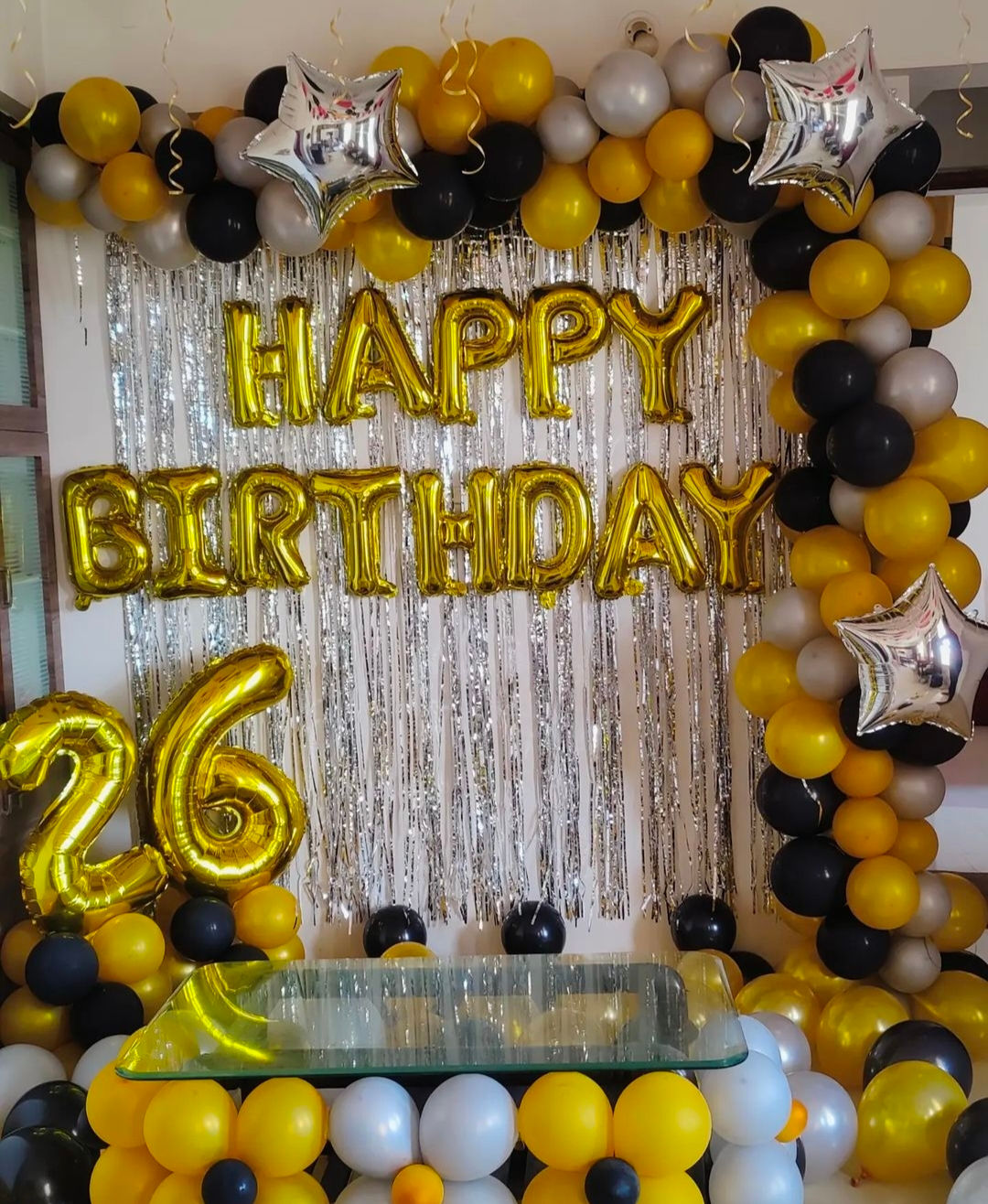 Gold Happy Birthday balloons with number 26, party decor backdrop.