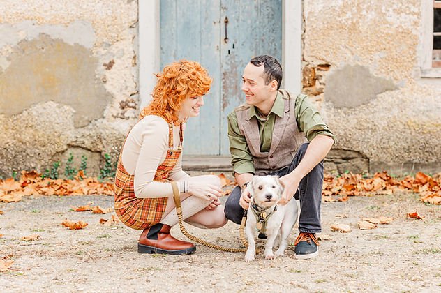 Jessah and Jason kneeling down with their pup Benji