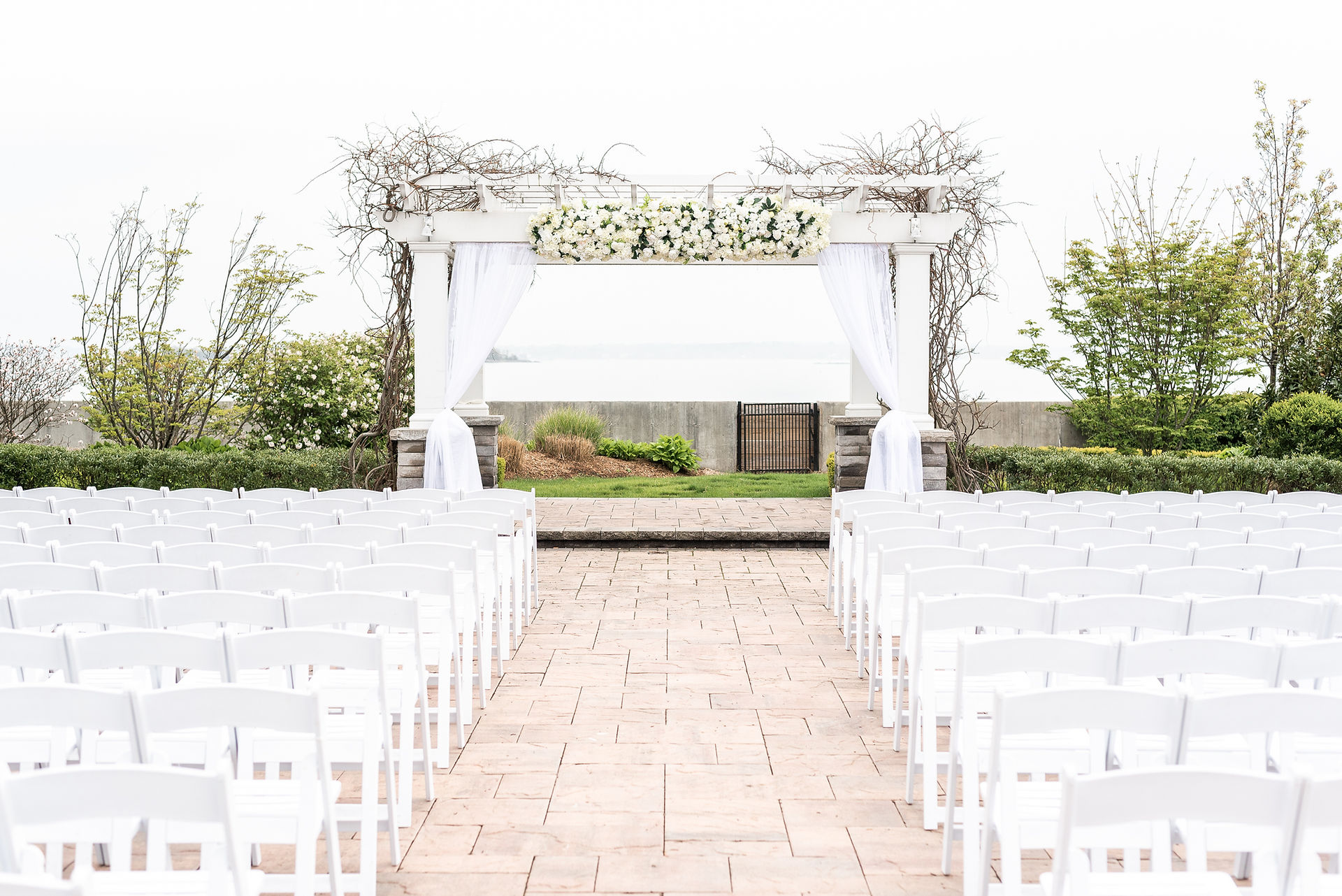 White florals and drapery for an outdoor ceremony at the Green Tree Country Club