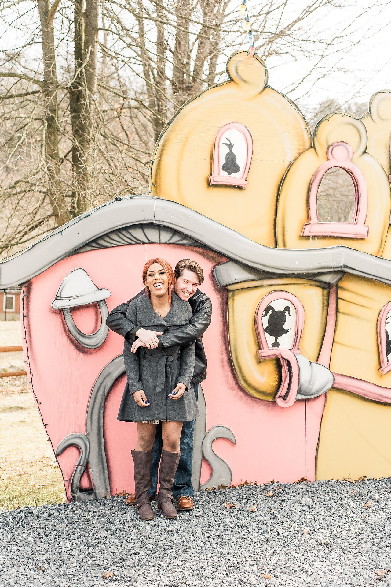Couple having fun at a Grinch exhibit at a zoo