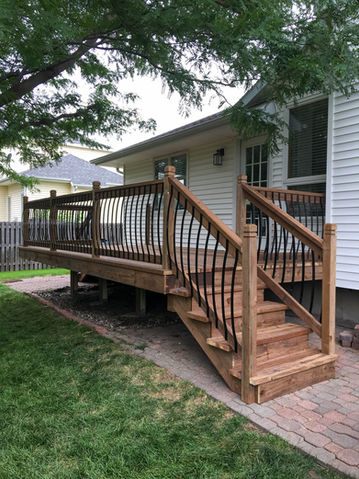Beautiful wood deck rails with dark metal balusters.