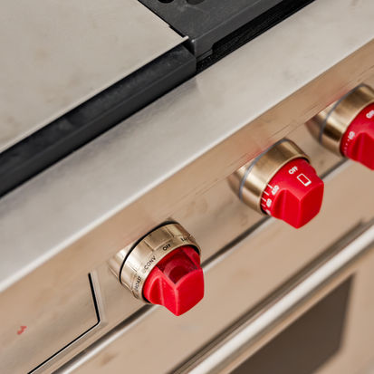 Stainless steel gas range with signature red knobs