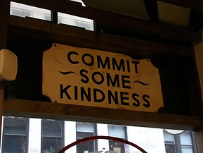 Yellow sign that says 'Commit Some Kindness'
