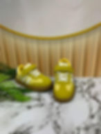 Yellow toddler sneakers with white stripes