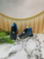Pair of black and blue athletic shoes