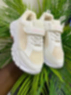 White sneakers with 'LOVE ME LOVE YOU' on strap