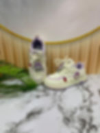 Cream children's shoes with purple details and cartoon charms