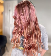 A photo of a woman's light pink and wavy hair