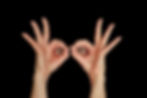 Hands framing staring eyes