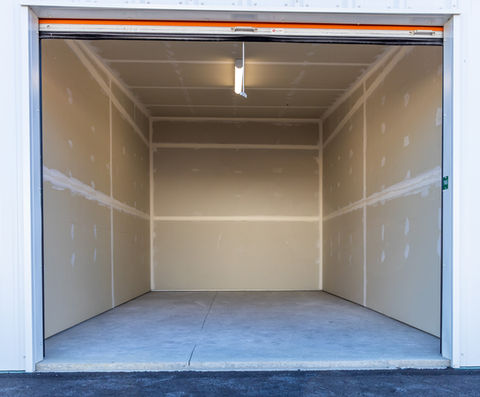 Empty storage shed with a white light on the ceiling