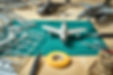 Top view on plastic model scale with accessories on green pad on wooden table
