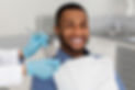 Cheerful african guy in dentist chair
