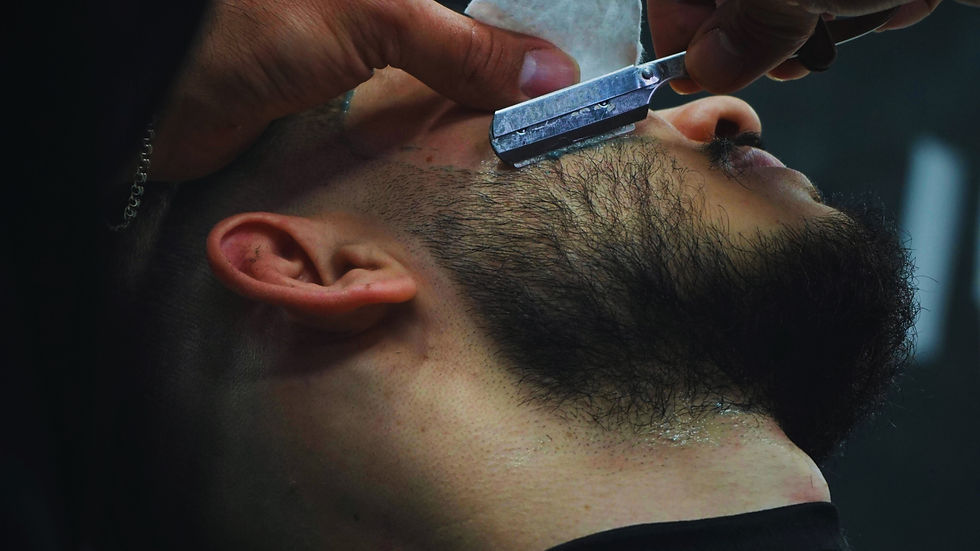 Man getting his beard shaved